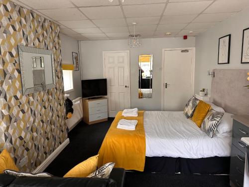 a bedroom with a bed and a tv in it at Berkswell Holiday Apartments in Blackpool