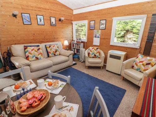 a living room with a couch and a table at Awelon in Newcastle Emlyn