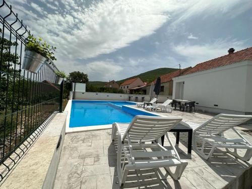a patio with chairs and a swimming pool at Villa Green Hill, Cista Velika, Imotski in Omiš