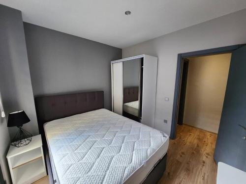 um quarto com uma cama branca e um espelho em Remta Real Estate em Istambul