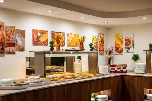 a buffet at a restaurant with food on display at BSA Gradina Hotel & Aquapark - All Inclusive in Golden Sands