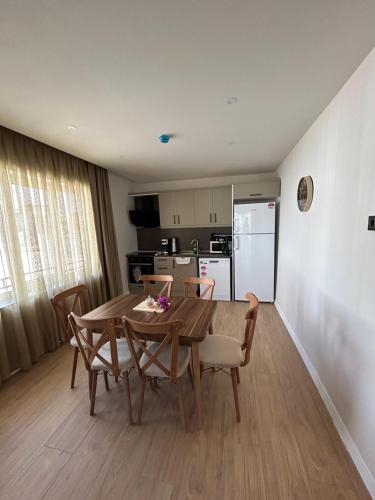 a kitchen with a table and chairs and a refrigerator at BD Suites in Bodrum City