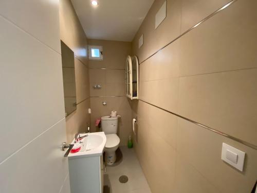 a small bathroom with a toilet and a sink at Apartamento Peniscola centro in Peñíscola