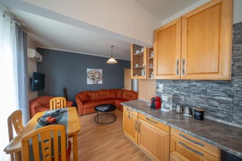 a kitchen and a living room with a couch at Your Home by the Sea for 3 in Xylokastro in Xylokastron