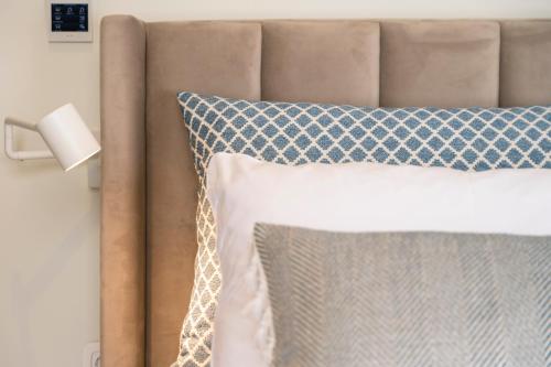 a bed with a blue and white pillow and a lamp at Mar-Gi 25 in Aiándion