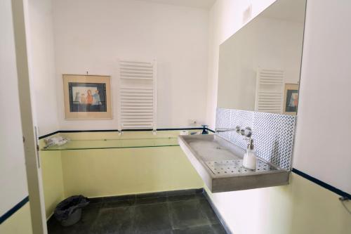 y baño con lavabo y espejo. en Giacaranda B&B, en Castellabate