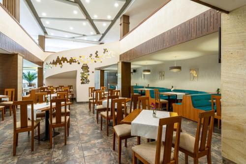 a restaurant with tables and chairs in a room at BSA Gradina Hotel - All Inclusive & Private Beach in Golden Sands