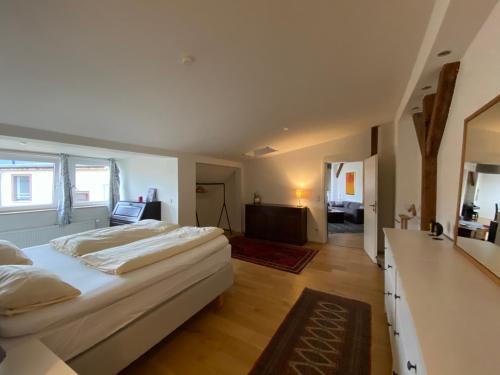 a bedroom with a large white bed and a television at FBApartments in Berlin