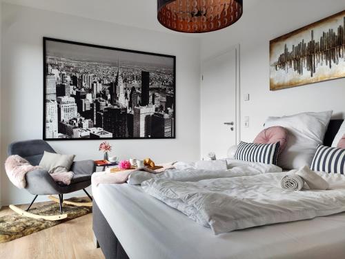 a living room with a bed and a couch at Penthouse mit Whirlpool im Herzen von Niedersachsen in Burgwedel
