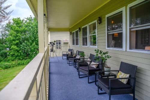 a row of chairs on the porch of a house at Brass Lantern Inn in Stowe
