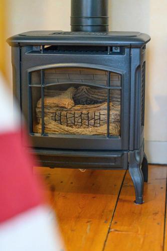 a blue stove with a blanket inside of it at Brass Lantern Inn in Stowe