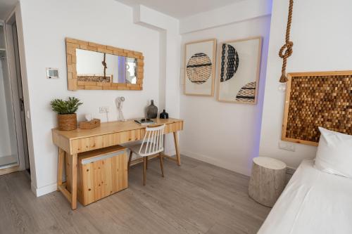 a bedroom with a desk and a bed at Blue Harbour Boutique in Ayia Napa