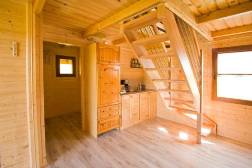 a log cabin with a staircase in a room at Polna Przystań in Uherce Mineralne