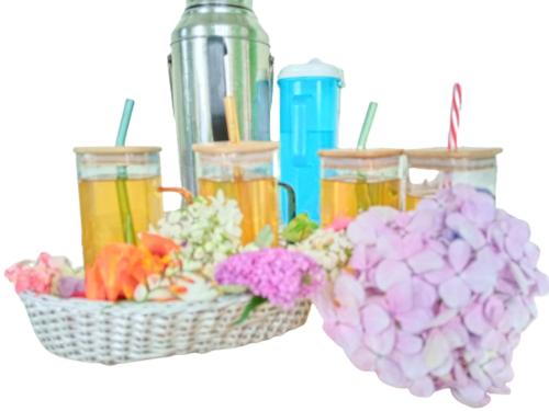 two baskets of flowers and drinks and a bowl of flowers at International Youth Hostel and Homestay Kurseong Bazar in Kurseong