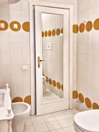 a white bathroom with a toilet and a sink at ViSte in Porto Santo Stefano