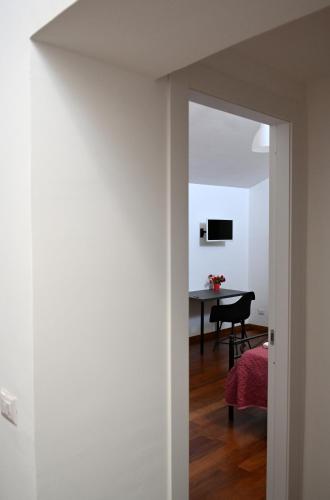 a hallway with a room with a table and a chair at Loft Mazzini in Caserta