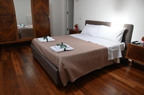a bedroom with a bed with two towels on it at Loft Mazzini in Caserta