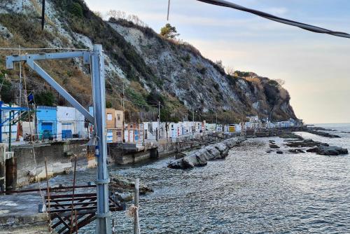 a group of houses on a hill next to the water at casapepa in Ancona