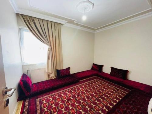 a room with a red bed and a window at Beautiful Apartment for rent in Beylikduzu