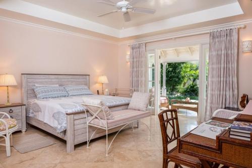 a bedroom with a bed and a table and a desk at Sunny Vacation Villa No 11 in Bridgetown