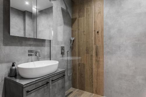 a bathroom with a white sink and a shower at Jim & Jo House in Thessaloniki