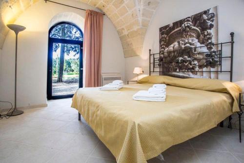 En eller flere senge i et værelse på Villa Lucrezio Resort