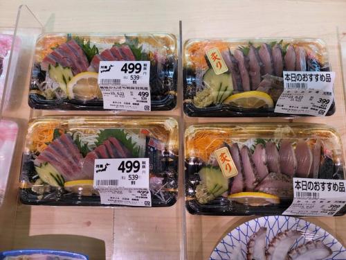 a display case with different types of food in plastic containers at 하루카오후나에 민숙 in Tsushima