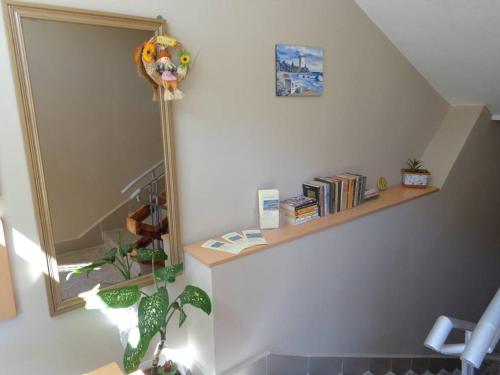 a room with a mirror and a shelf with books at Guest rooms Rusalka in Kranevo