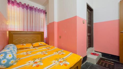 a bedroom with a bed with flowers on it at Hotel Rose Haven Residential in Dhaka