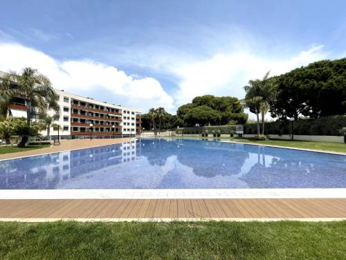 a large swimming pool in front of a building at LuxuryCambrils Resort&Spa in Cambrils