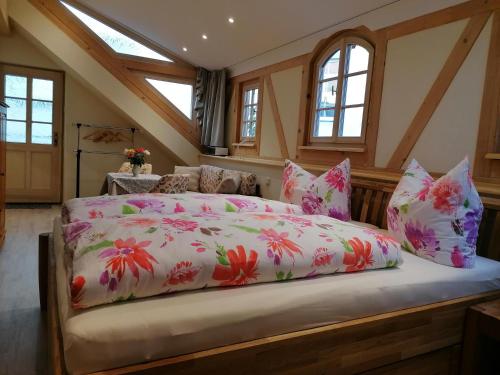 a bedroom with a large bed with pink flowers at Altstadtidyll in Meißen