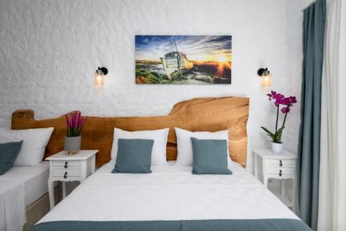 1 Schlafzimmer mit 2 Betten mit blauen und weißen Kissen in der Unterkunft Fethi Baba Konağı in Izmir