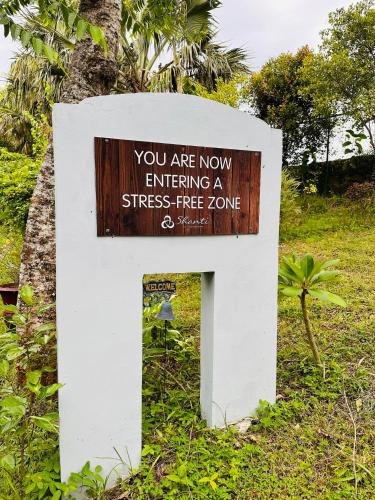 a sign that says you are now entering a stress free zone at Shanti Wellness Sanctuary in Lemery