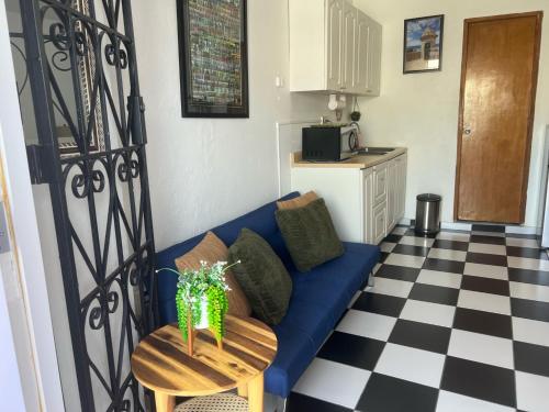 a living room with a blue couch and a table at 310Guest-House La Vida in San Juan