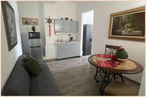 a living room with a couch and a table at 310Guest-House La Vida in San Juan