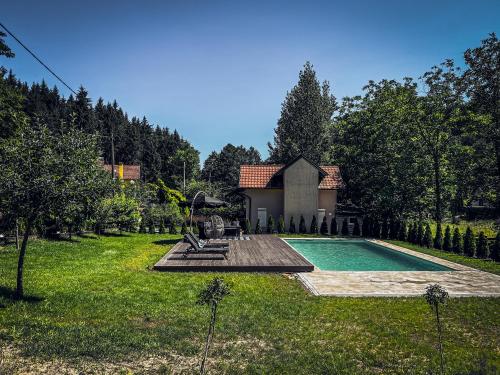 einen Hinterhof mit einem Pool und einem Haus in der Unterkunft Tronoska Oaza Korenita, Loznica in Loznica