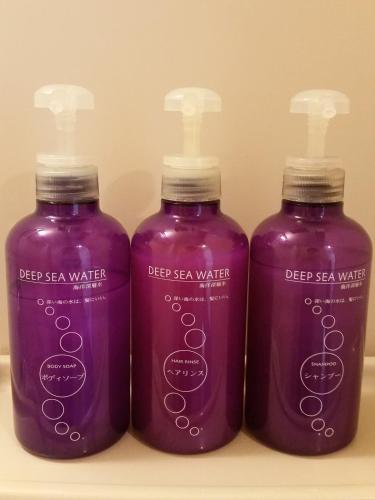 three bottles of deep sea water sitting on a shelf at Business Hotel Sunpu in Shizuoka