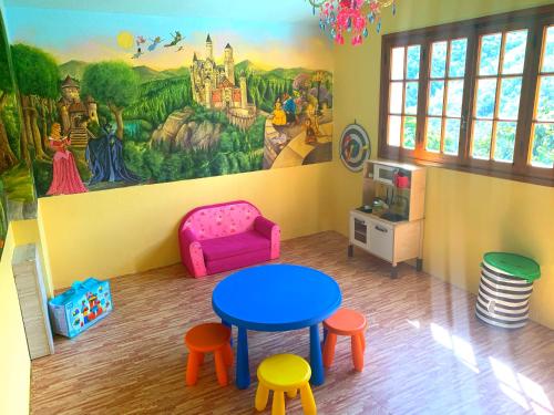 a room with a table and chairs and a mural at La Favorita Apricale B&B & Ristorante in Apricale