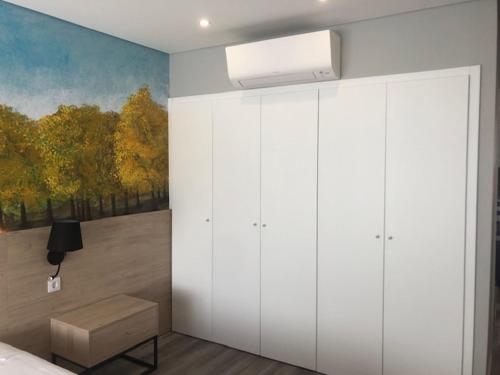 a bedroom with a painting on the wall at Hostel S. Miguel FitNCare in Guarda