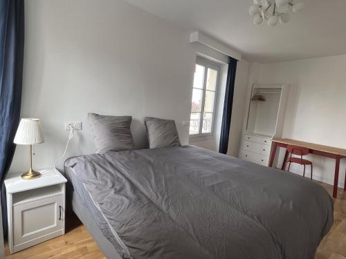 sypialnia z łóżkiem, stołem i oknem w obiekcie Villa 3 Bedrooms - Proche VERSAILLES ORLY PARIS PARKING GRATUIT w mieście Les Clayes-sous-Bois