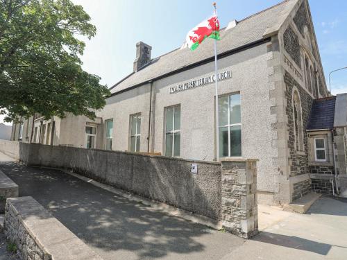 a building with a flag on top of it at The School House in Holyhead