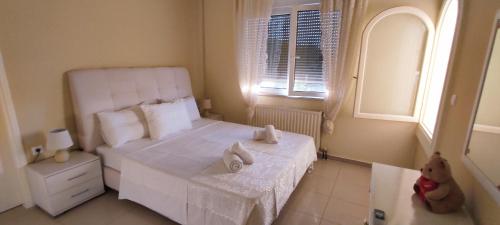 a bedroom with a white bed with towels on it at Katerina's Residence Chania With Panoramic View in Perivólia