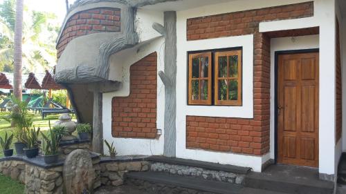 a brick house with a door and a window at The Nature Park Villa in Sigiriya