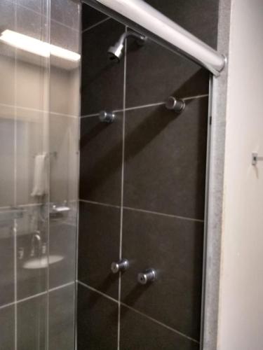 a shower with a glass door in a bathroom at Matiz Multi Suites in Duque de Caxias