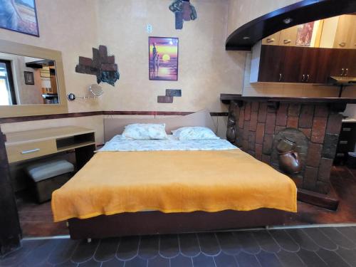a bedroom with a bed and a counter and a sink at LENA Apartman 45m2 Sokobanja-CENTAR in Soko Banja