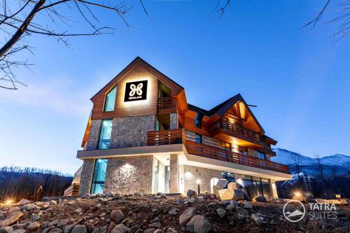 a large house with the sx sign on it at TATRA SUITES Vila HIMALAYA in Tatranská Lomnica