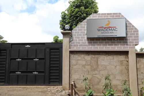 a garage with a sign that reads walding brooklyn ducks inn at Wademac Arusha Inn Hotel in Arusha
