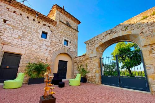an entrance to a stone building with a gate at DOMAINE DE LEJOS - Portes d'Albi in Lamillarié