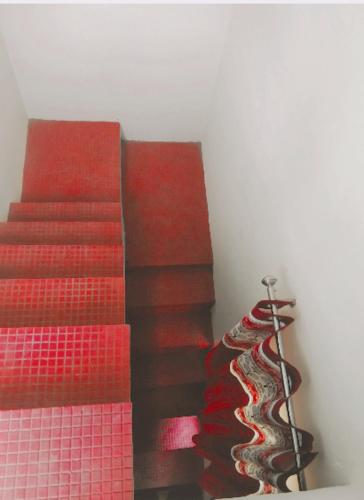 a set of red stairs with a red carpet at maa kalishila home stay in Ukhimath