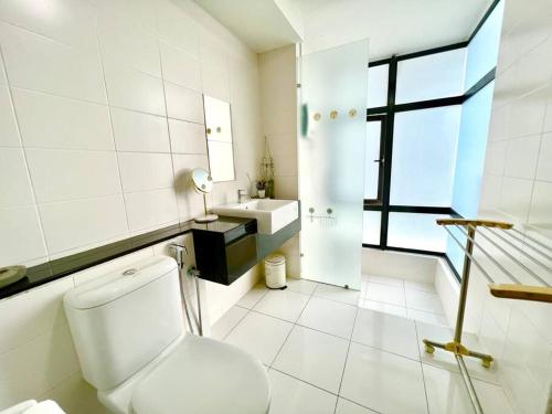 a white bathroom with a toilet and a sink at T2 1-10Pax 2Room Balcony Trefoil Setia Alam TV Wi-Fi in Shah Alam